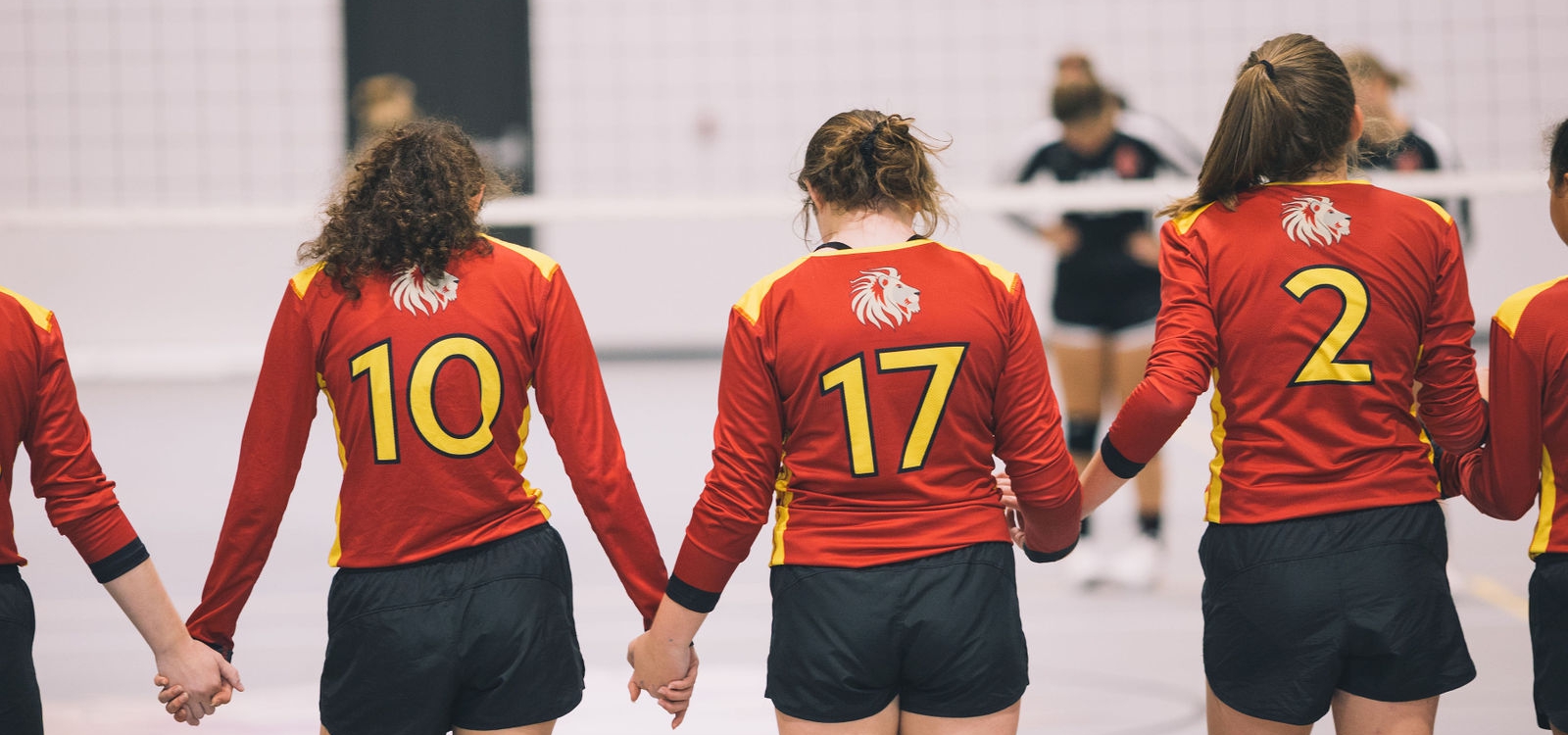 volleyball team holding hands