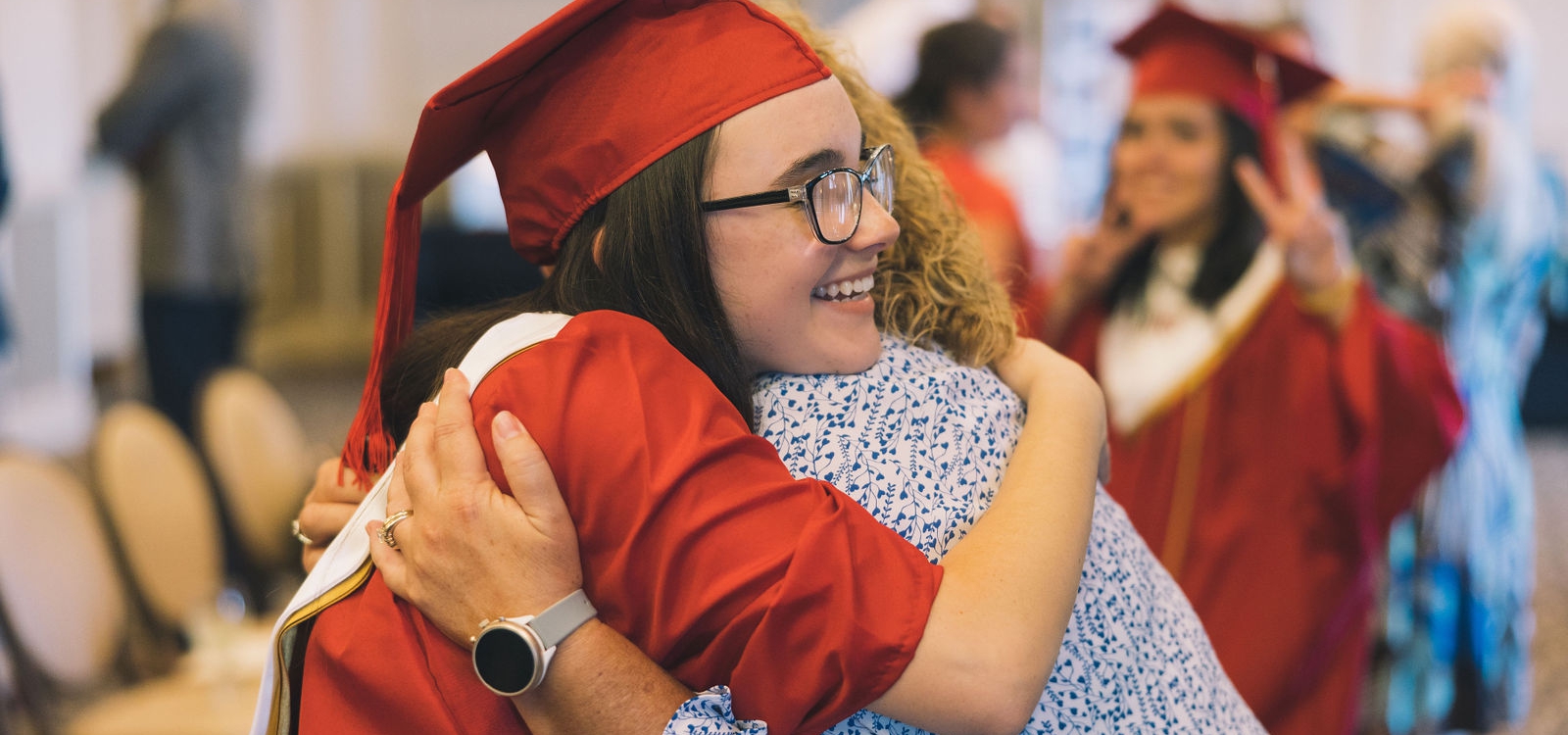 graduate hugging teacher