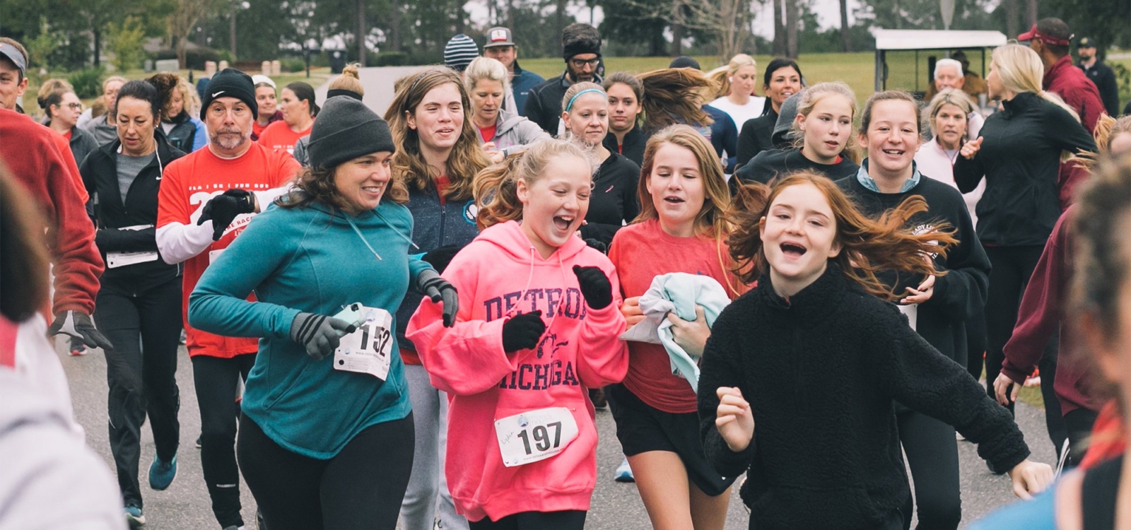 students and adults running in 5k race